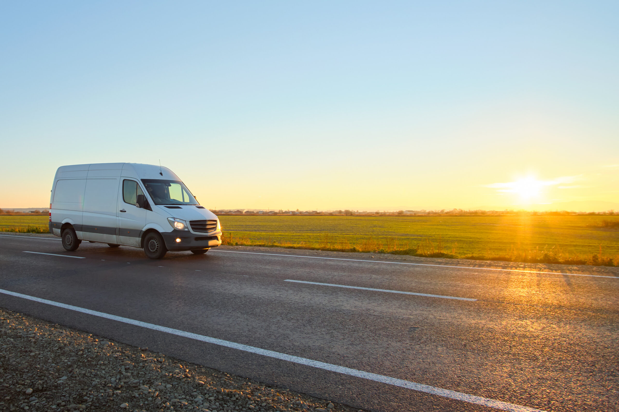 Small cargo van driving on highway hauling goods. Delivery transportation and logistics concept